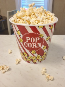 A tub of stovetop popcorn labeled popcorn on a white countertop.