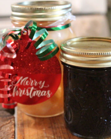 A jar of canned pears and canned blackberry jam for diy Christmas gifts.